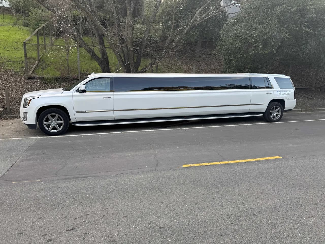 White Cadillac Escalade Limousine exterior with tinted windows for prom car rental in Burlingame, CA White Cadillac Escalade Limousine exterior with tinted windows for prom car rental in Burlingame, CA
