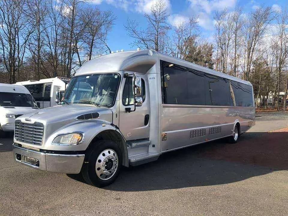 Silver Limousine Bus exterior with tinted windows for prom car rental in Memphis, TN Silver Limousine Bus exterior with tinted windows for prom car rental in Memphis, TN