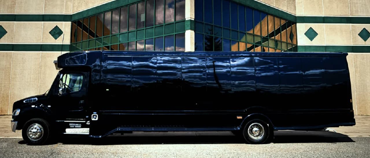Black 28 Passenger Party Bus exterior with tinted windows for party bus rental in Saint Paul, MN Black 28 Passenger Party Bus exterior with tinted windows for party bus rental in Saint Paul, MN