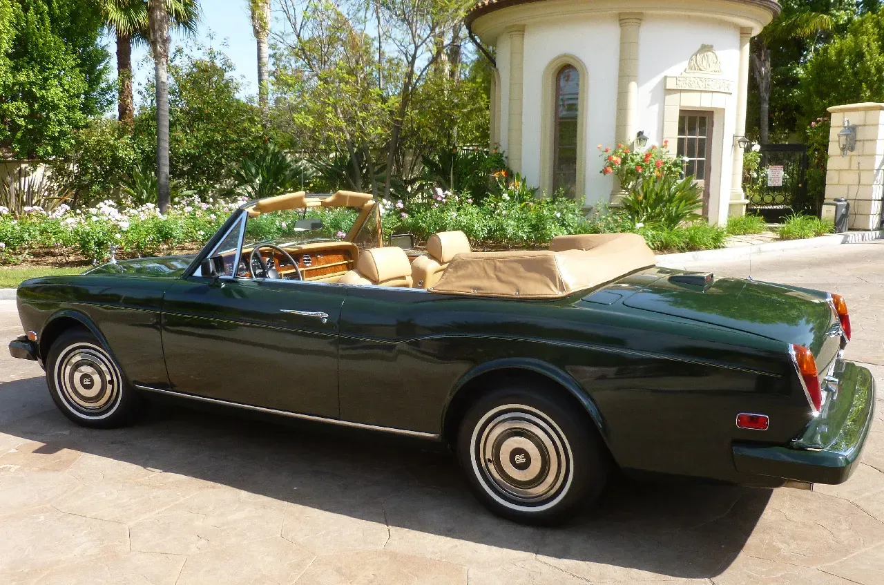 Green 1983 Rolls Royce Corniche Convertible exterior with convertible roof for wedding car rental in Burbank, CA