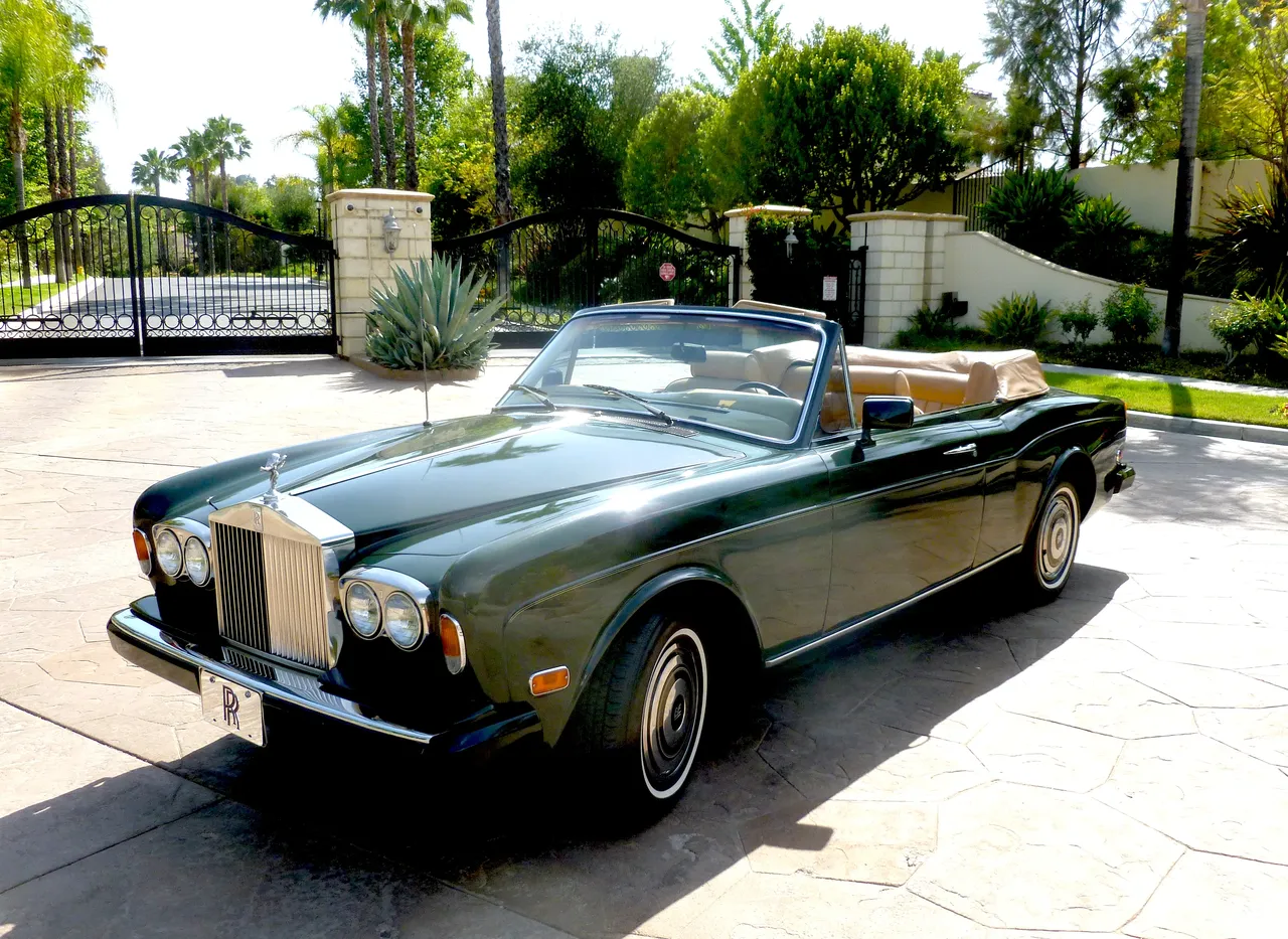 Green 1983 Rolls Royce Corniche Convertible with convertible roof for wedding car rental in Burbank, CA