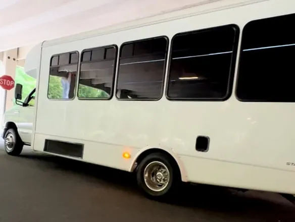 White Ford E-450 Series Party Bus; tinted windows