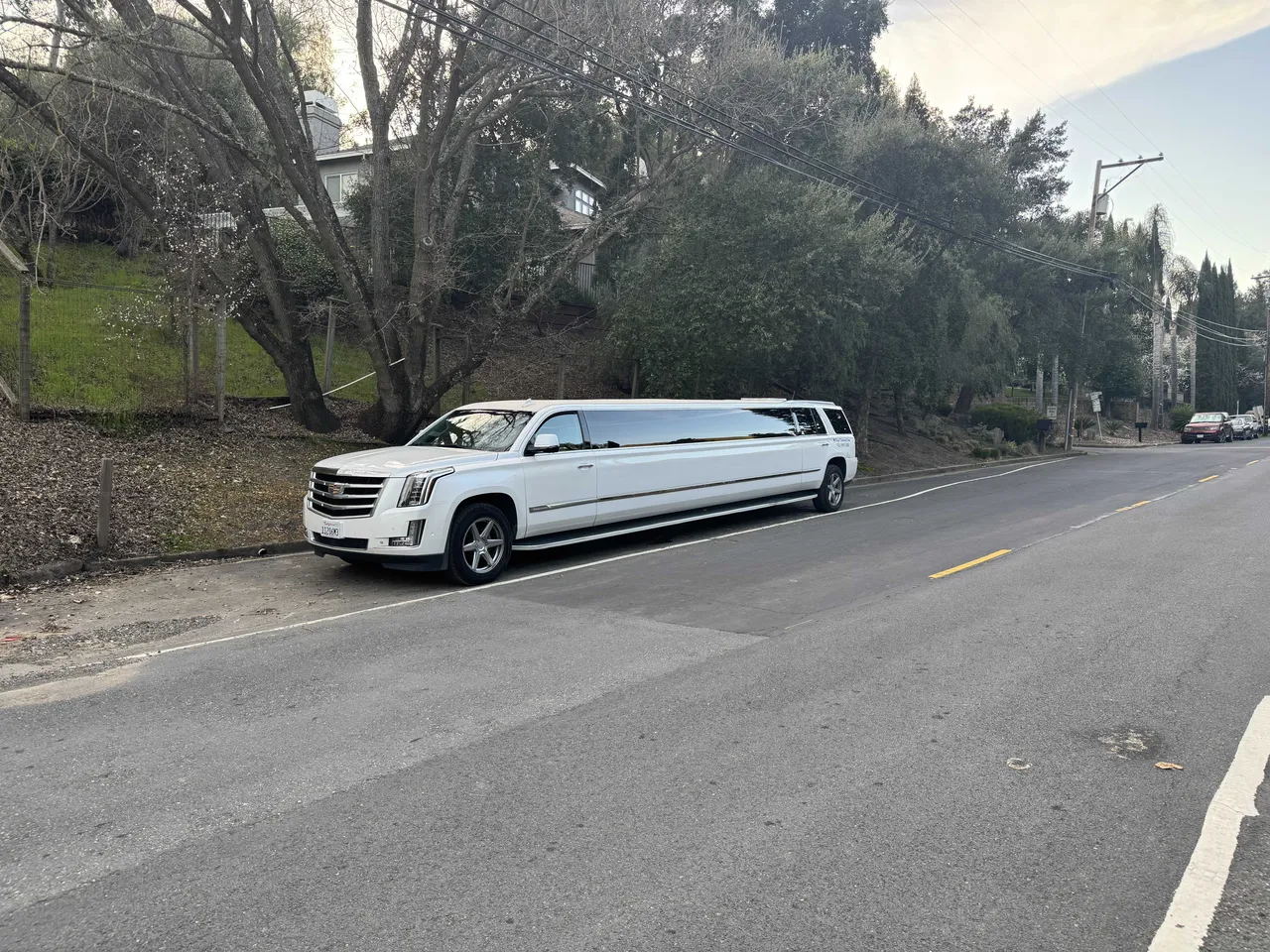 White Cadillac Escalade Limousine with tinted windows for hummer limo rental in Farmington, CA