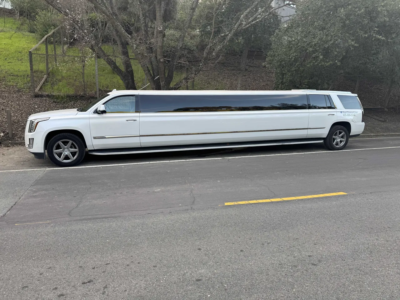 White Cadillac Escalade Limousine exterior with tinted windows for hummer limo rental in Farmington, CA