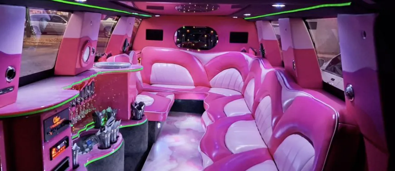 Chevrolet Suburban Limousine interior with sofa-style seating, LED accent lighting and bar area for limo rental in Florida Chevrolet Suburban Limousine interior with sofa-style seating, LED accent lighting and bar area for limo rental in Florida
