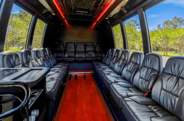 18 Passenger Executive Limo Bus interior with perimeter lounge seating and LED ceiling lighting for party bus rental