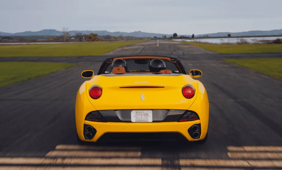 Yellow Ferrari California Convertible with convertible roof for wedding car rental in Burson, CA