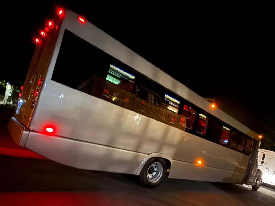 Silver Freightliner Party Bus exterior with tinted windows for party bus rental in North Attleboro, MA