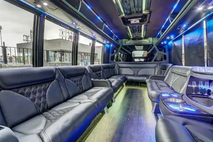 Grech Party Bus Grech Party Bus interior with perimeter lounge seating, sofa-style seating and LED accent lighting for party bus rental