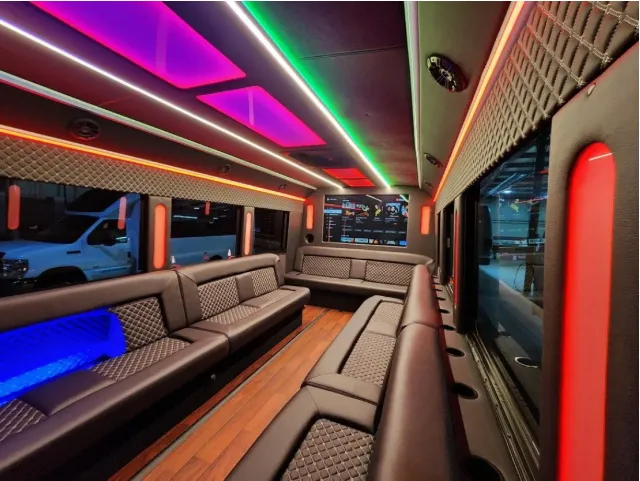 Limousine Bus interior with perimeter lounge seating, LED accent lighting and LED ceiling lighting for prom car rental in Kenner, LA