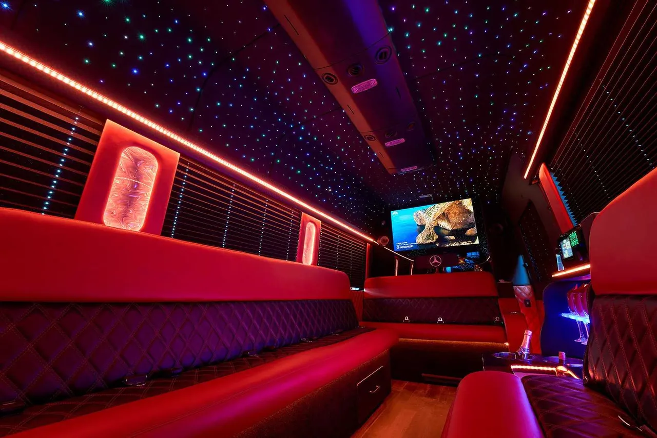 Limousine Bus interior with perimeter lounge seating, window shades and LED accent lighting, photo 2 for party bus rental in Wisconsin Limousine Bus interior with perimeter lounge seating, window shades and LED accent lighting, photo 2 for party bus rental in Wisconsin