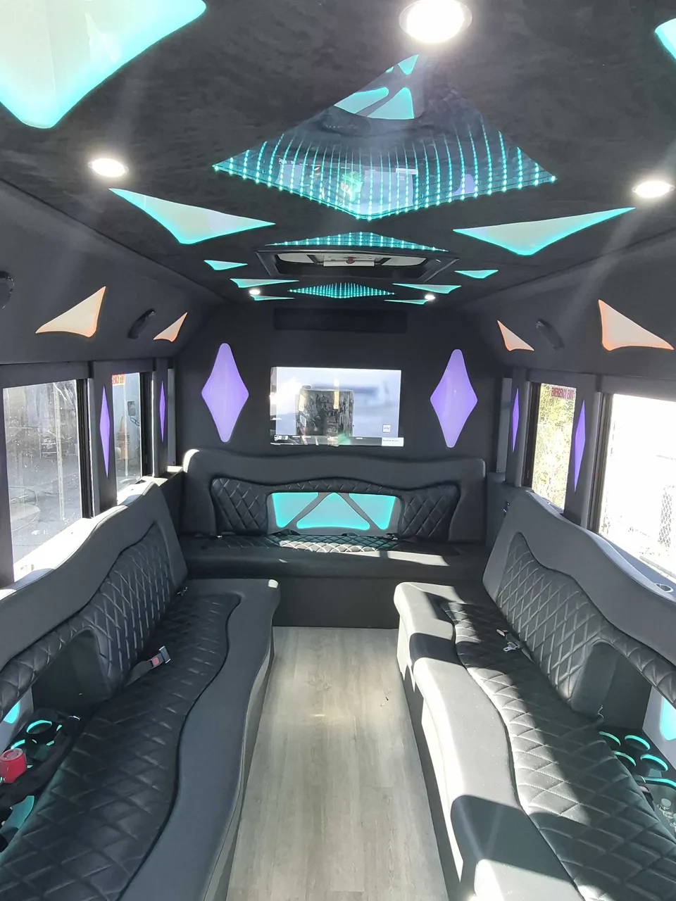 Limousine Bus interior with perimeter lounge seating, LED accent lighting and LED ceiling lighting, photo 3 for party bus rental in Memphis, TN