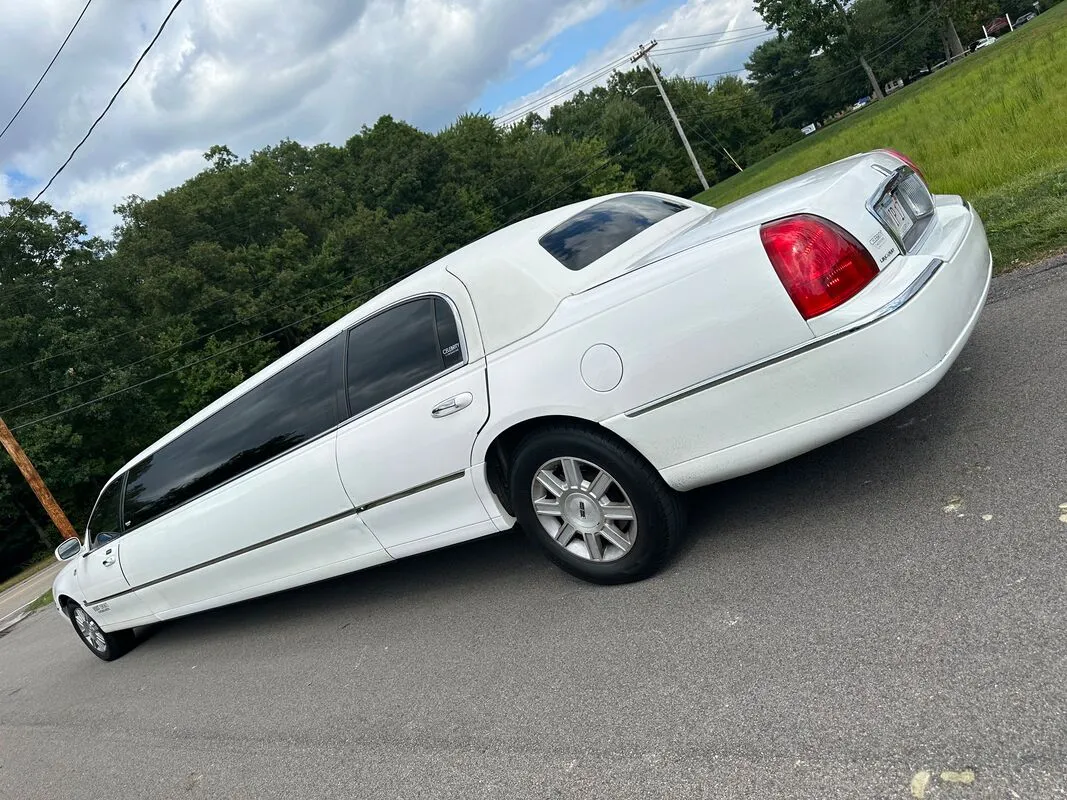 White Lincoln Town Car Limousine exterior with tinted windows, photo 5 for limo rental in North Attleboro, MA