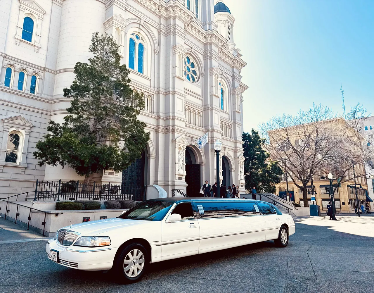 White Lincoln Town Car Limousine with tinted windows for wedding car rental in Burson, CA