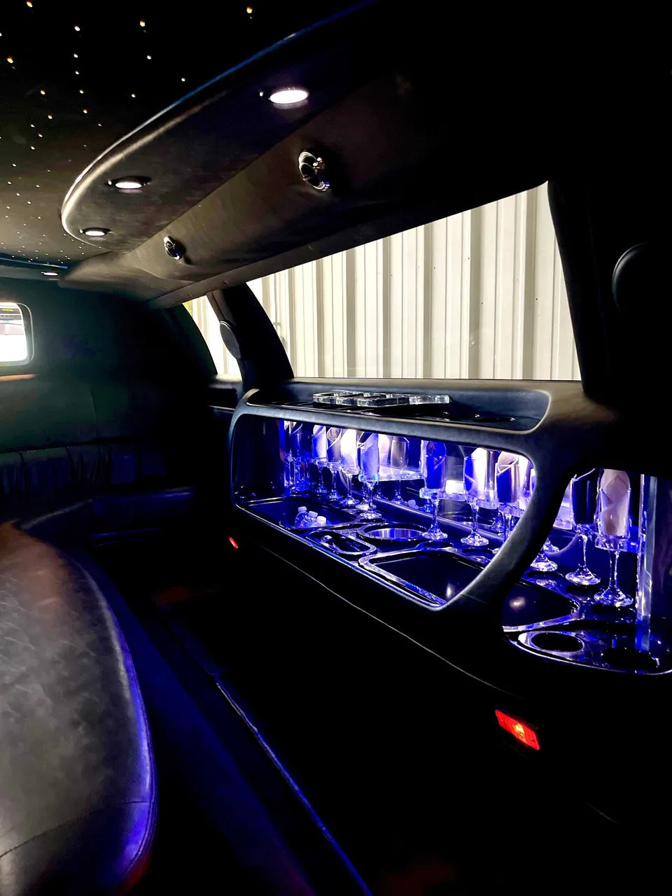 Lincoln Town Car Limousine interior with LED accent lighting, starlight or fiber-optic ceiling and glassware holders for wedding car rental in Burson, CA