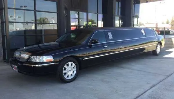 Black Lincoln Town Car Limousine; tinted windows