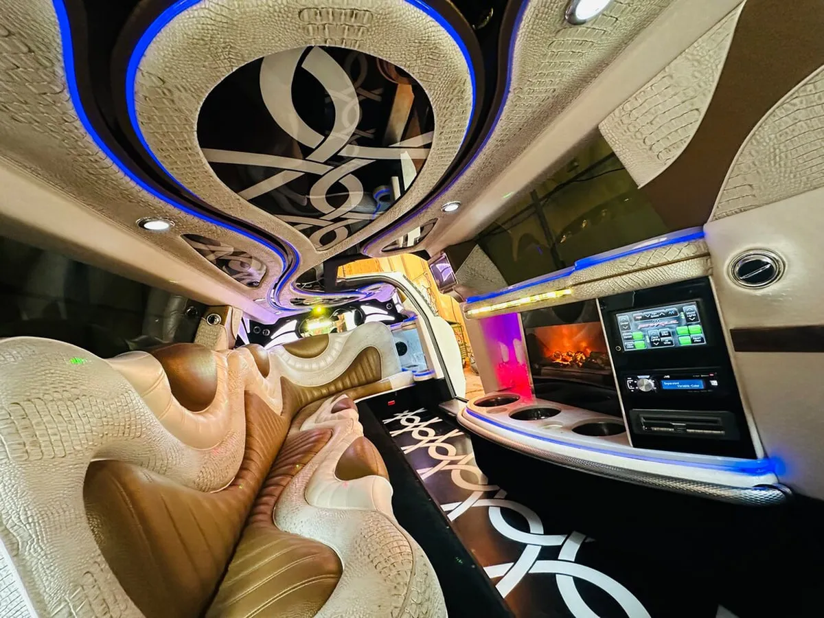 Mercedes-Benz Jet Doors Limousine interior with perimeter lounge seating and LED accent lighting, photo 11 for limo rental in North Attleboro, MA
