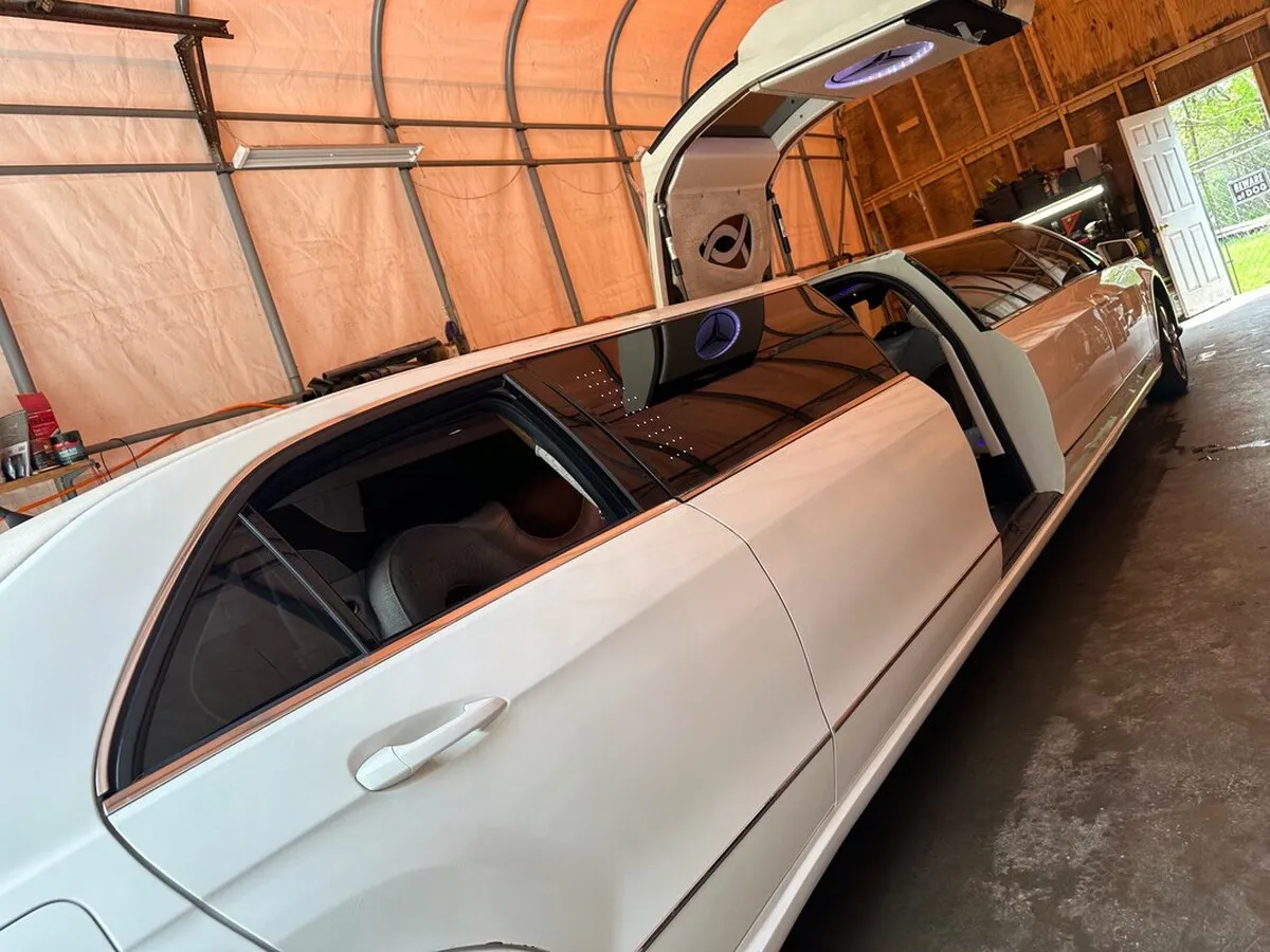 White Mercedes-Benz Jet Doors Limousine exterior with tinted windows and bridal (jet) door for limo rental in North Attleboro, MA
