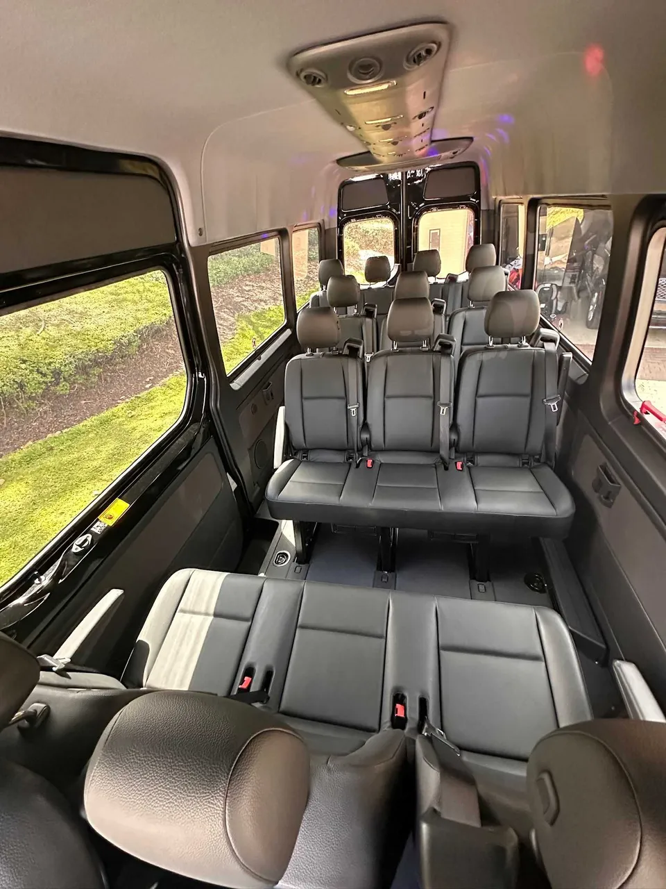Mercedes Limo Sprinter interior with passenger seat belts for party bus rental in Pinetta, FL