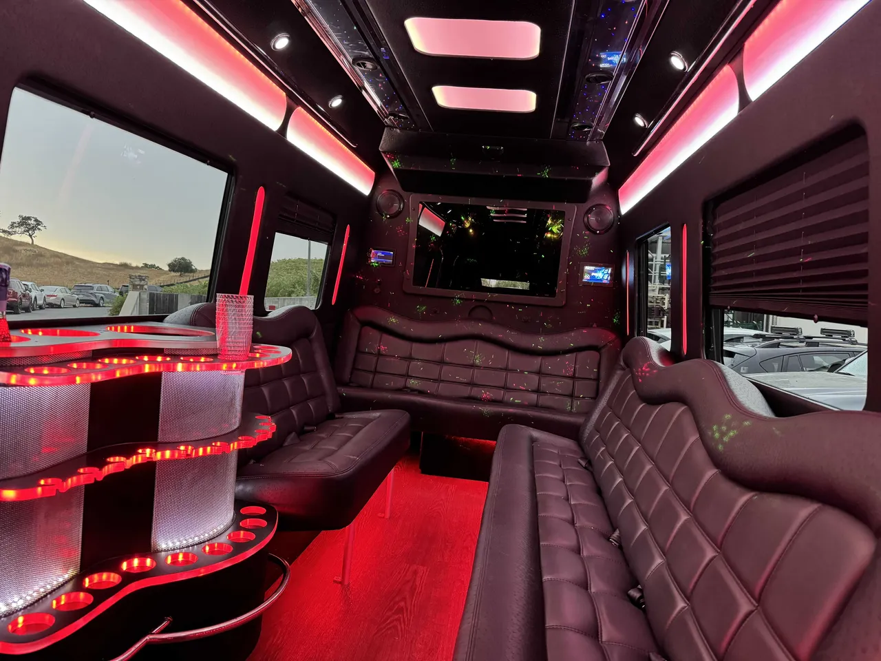 Mercedes-Benz Party Bus interior with perimeter lounge seating, window shades and LED accent lighting, photo 6 for prom car rental in Burson, CA