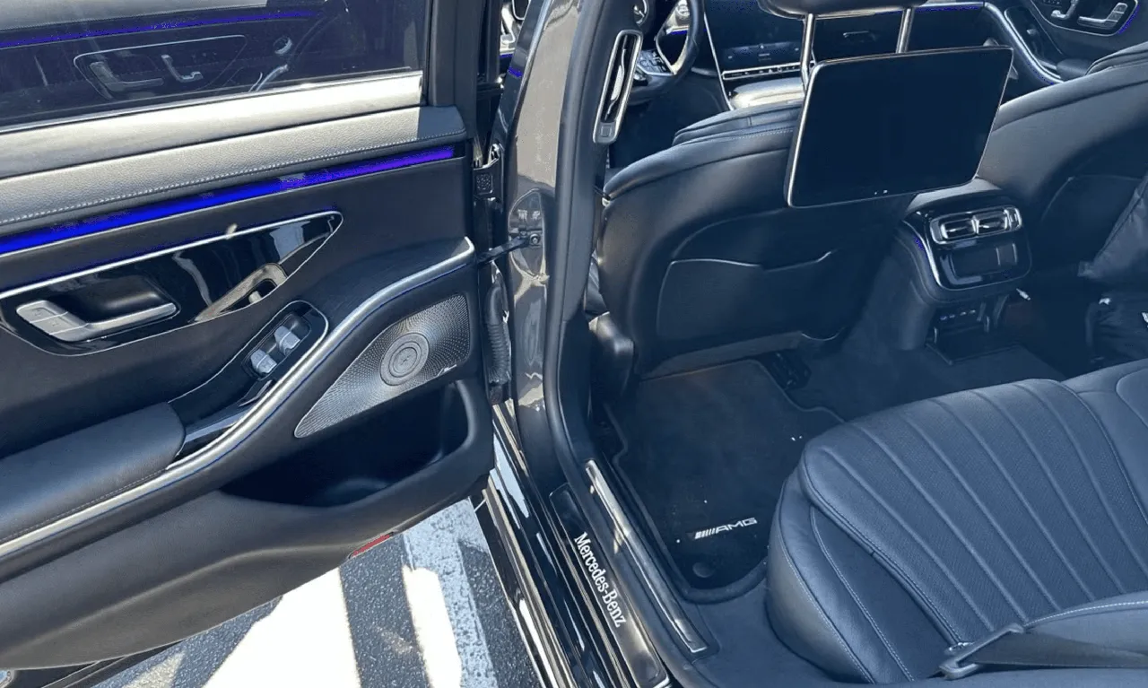 Mercedes-Benz S-Class interior with LED accent lighting and rear-seat entertainment screens for wedding car rental in Keene, CA