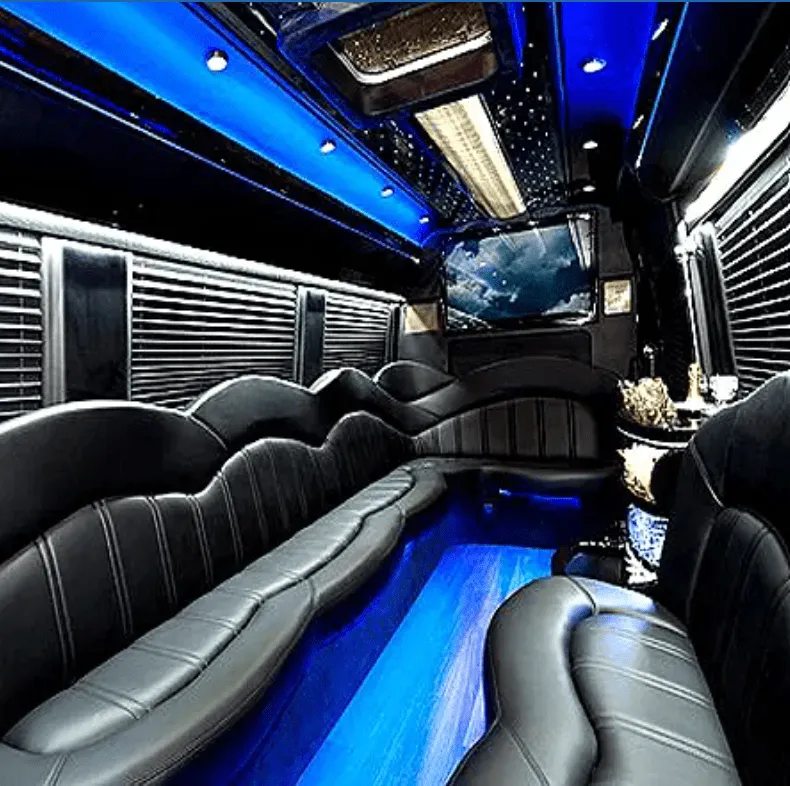 Mercedes-Benz Sprinter Limousine interior with perimeter lounge seating, window shades and LED accent lighting for limo rental in Glendale, CA