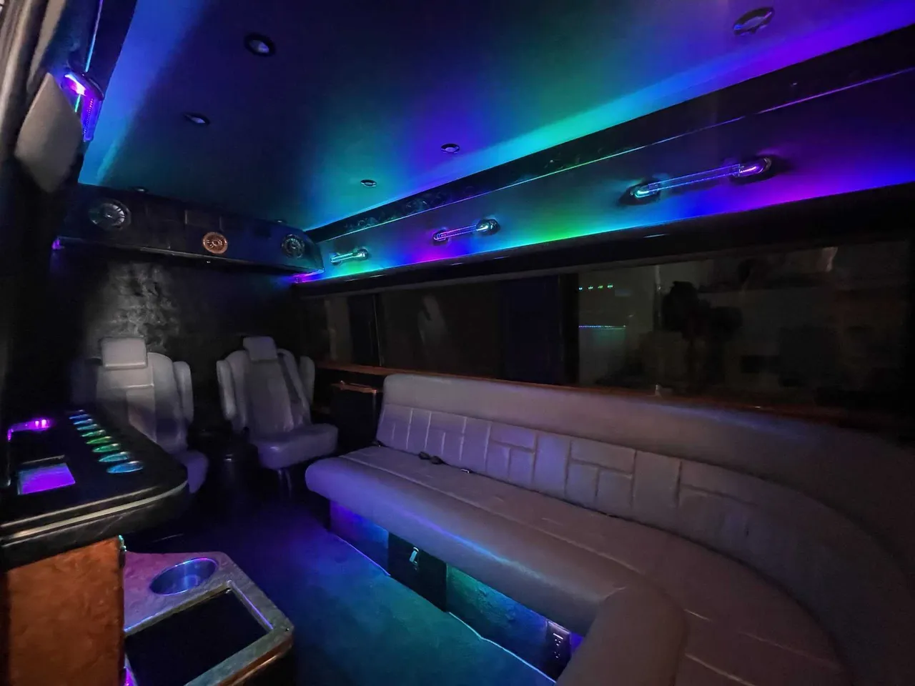 Mercedes Sprinter Limo interior with sofa-style seating, captain's chairs and LED accent lighting, photo 2 for party bus rental in Pinetta, FL