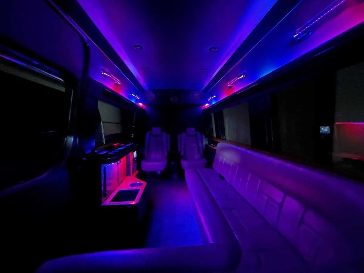 Mercedes Sprinter Limo interior with sofa-style seating, captain's chairs and LED accent lighting, photo 3 for party bus rental in Pinetta, FL