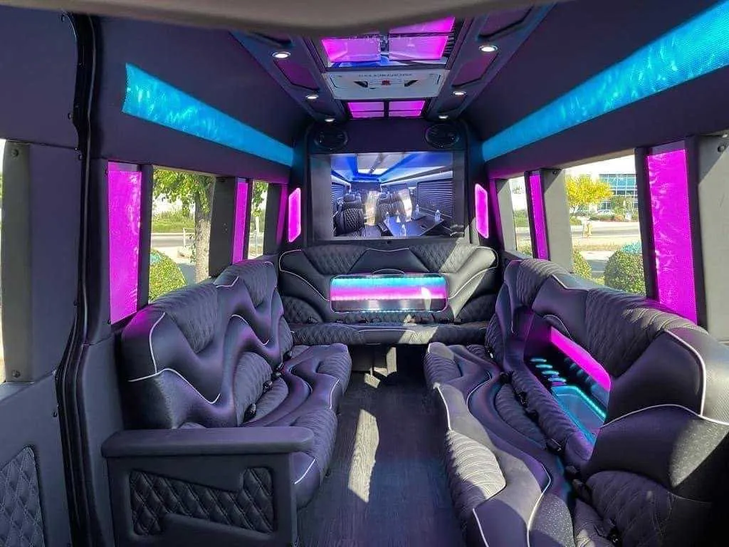 Mercedes Sprinter Limo interior with sofa-style seating, LED accent lighting and LED ceiling lighting for party bus rental in Burson, CA