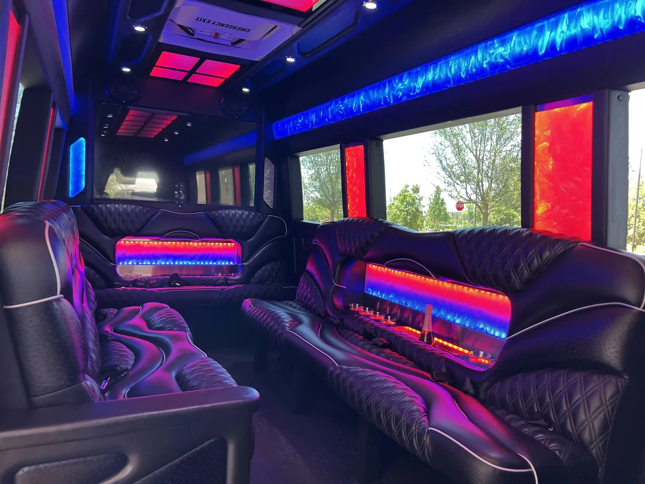 Mercedes Sprinter Limo interior with sofa-style seating, LED accent lighting and LED ceiling lighting, photo 2 for party bus rental in Burson, CA
