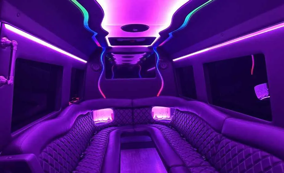 Mercedes-Benz Sprinter Limousine interior with perimeter lounge seating and LED accent lighting for limo rental in Burson, CA