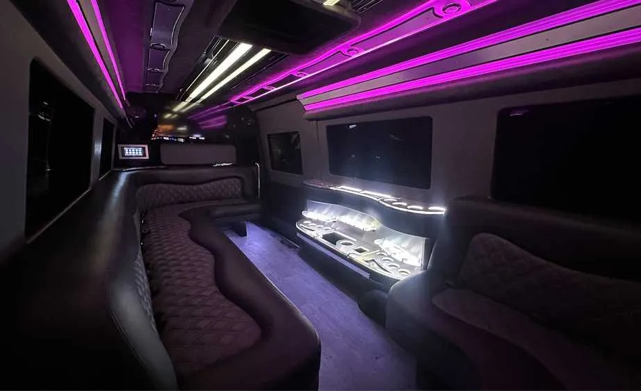 Mercedes-Benz Sprinter Limousine interior with perimeter lounge seating, LED accent lighting and bar area, photo 3 for limo rental in Burson, CA