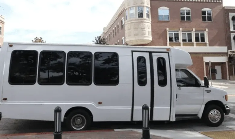 White 16 Passenger Party Bus exterior with tinted windows for party bus rental in Burbank, CA
