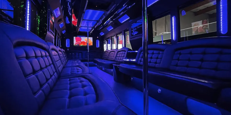26 Passenger Party Bus interior with perimeter lounge seating, LED accent lighting and LED ceiling lighting for party bus rental in Burson, CA