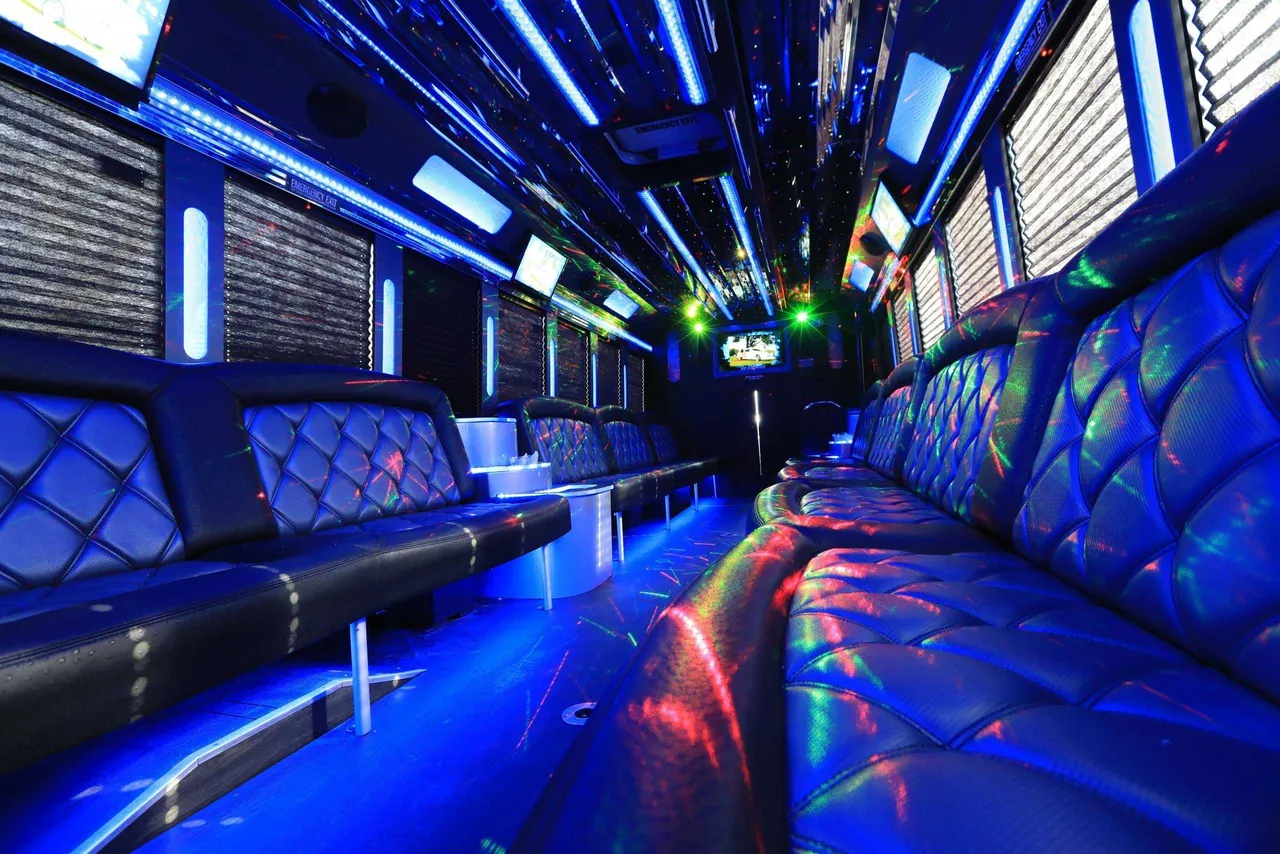 30 Passenger Party Bus interior with perimeter lounge seating, window shades and LED accent lighting for party bus rental in Dallas, TX 30 Passenger Party Bus interior with perimeter lounge seating, window shades and LED accent lighting for party bus rental in Dallas, TX