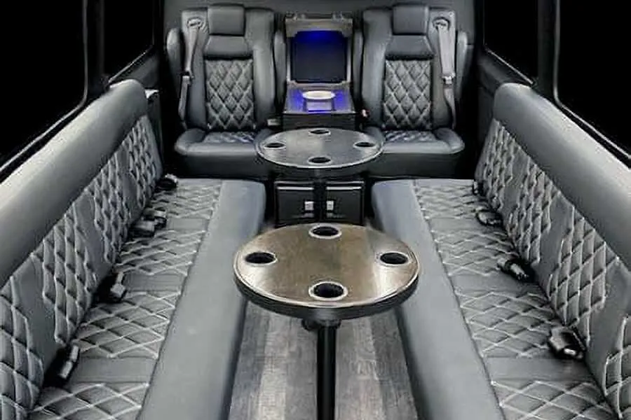 Sprinter Van- 12 Pax Sprinter Van- 12 Pax interior with perimeter lounge seating, captain's chairs and passenger tables for party bus rental